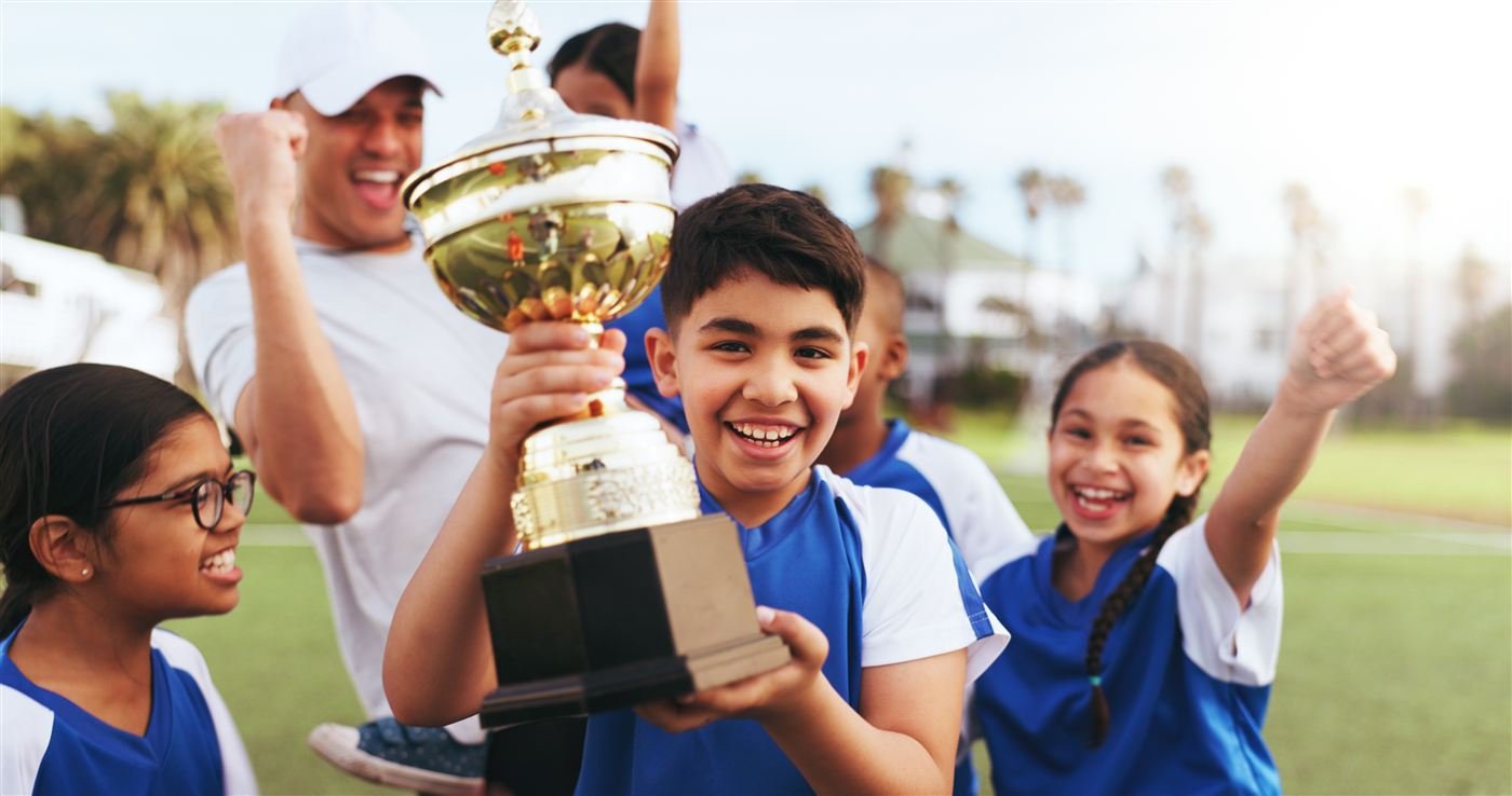 Students celebrating Olympiad success with a trophy